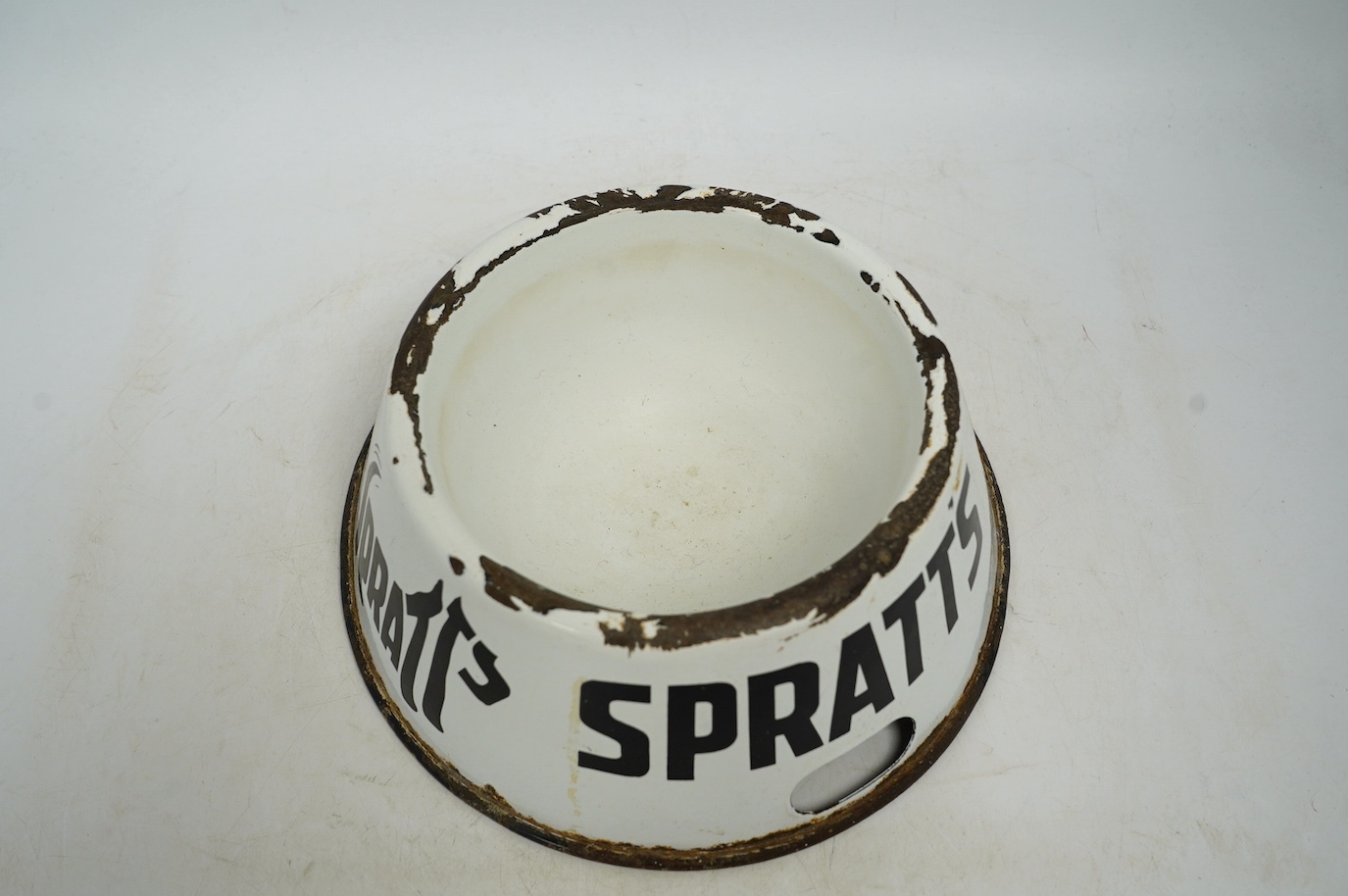 A vintage Spratt’s circular enamel advertising dog bowl, 27cm diameter, 10cm high. Condition - poor